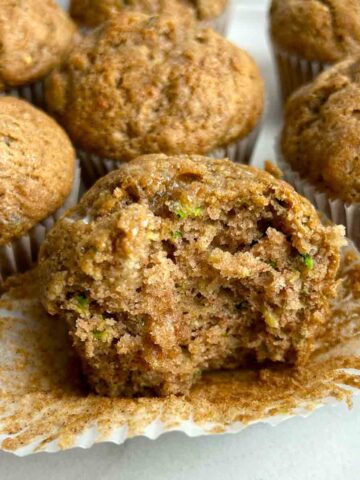 close up of zucchini muffin with bite taken out of it.