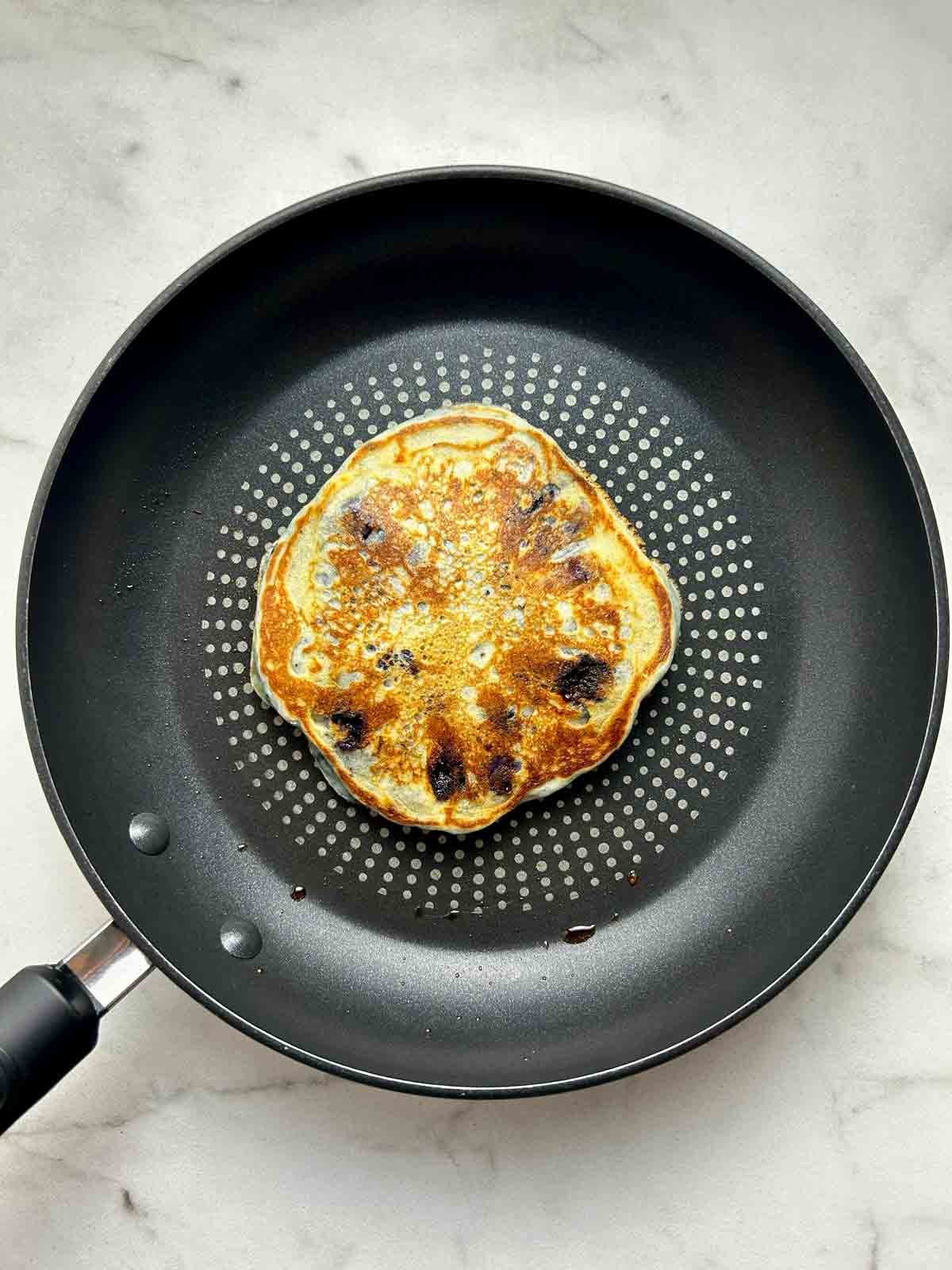 pancake after being flipped in pan.