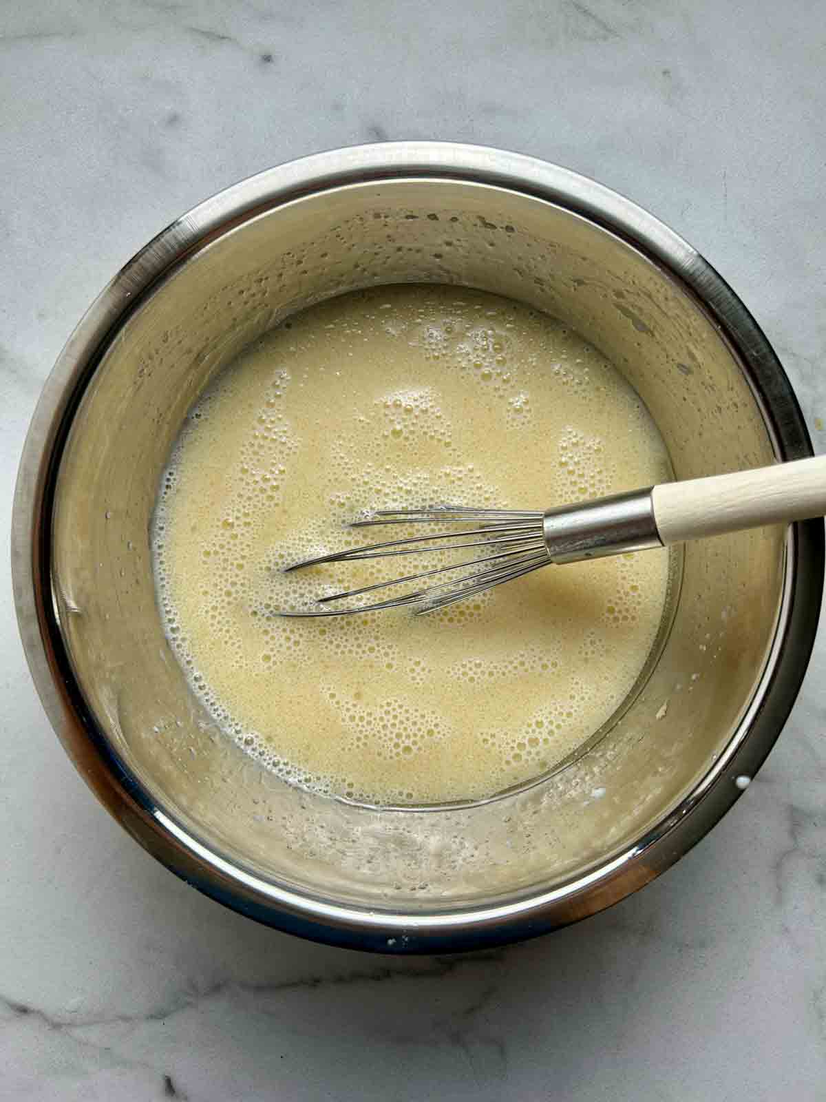 wet ingredients whisked in bowl.