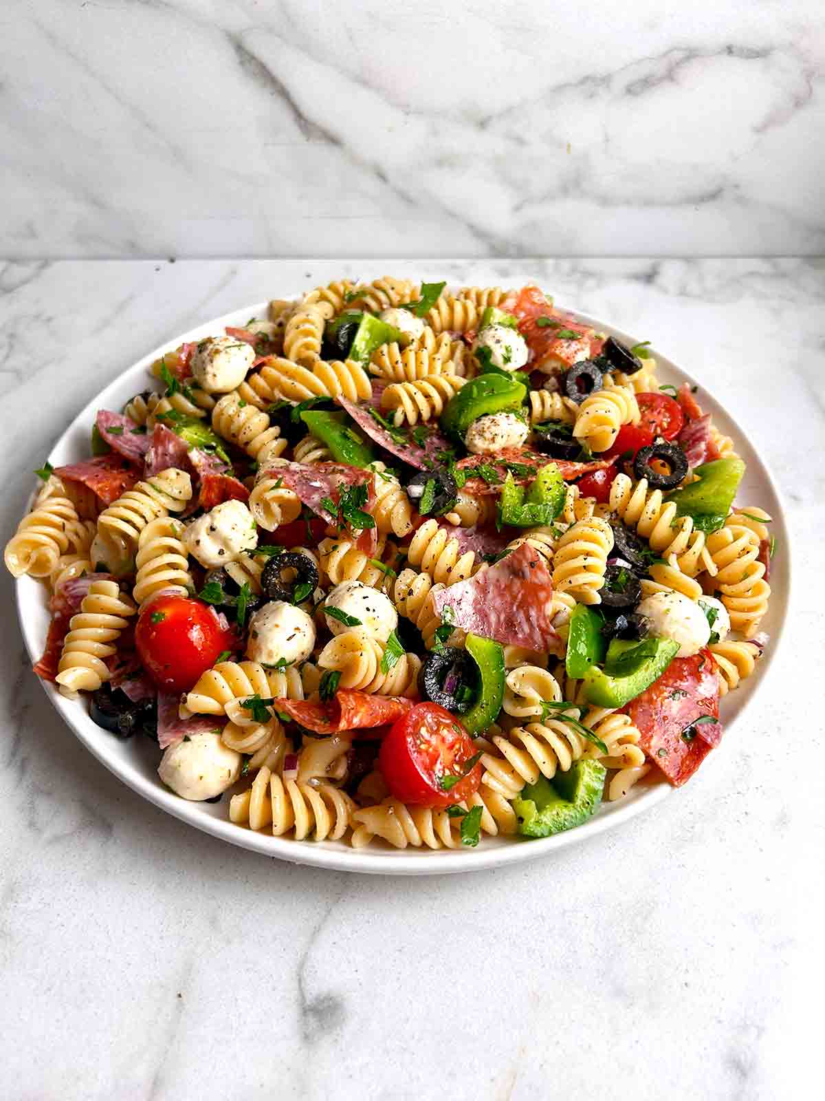 Italian pasta salad on white plate.