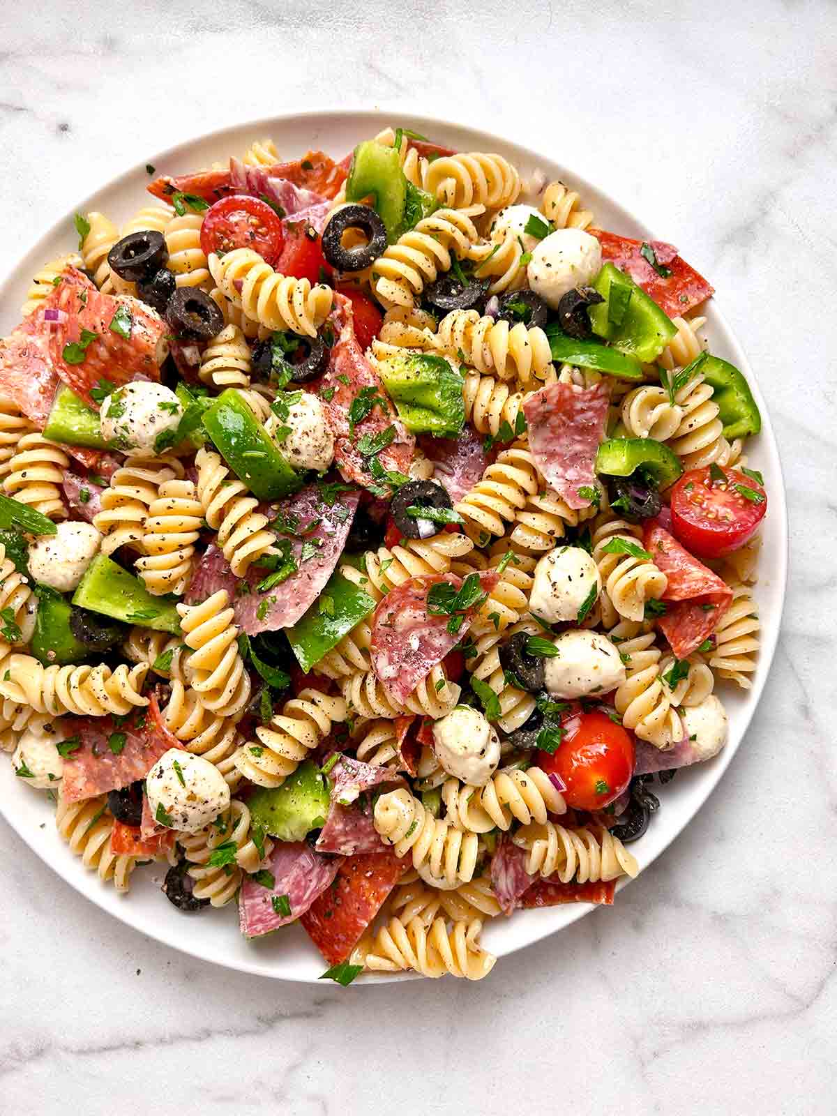 Italian pasta salad on white plate.